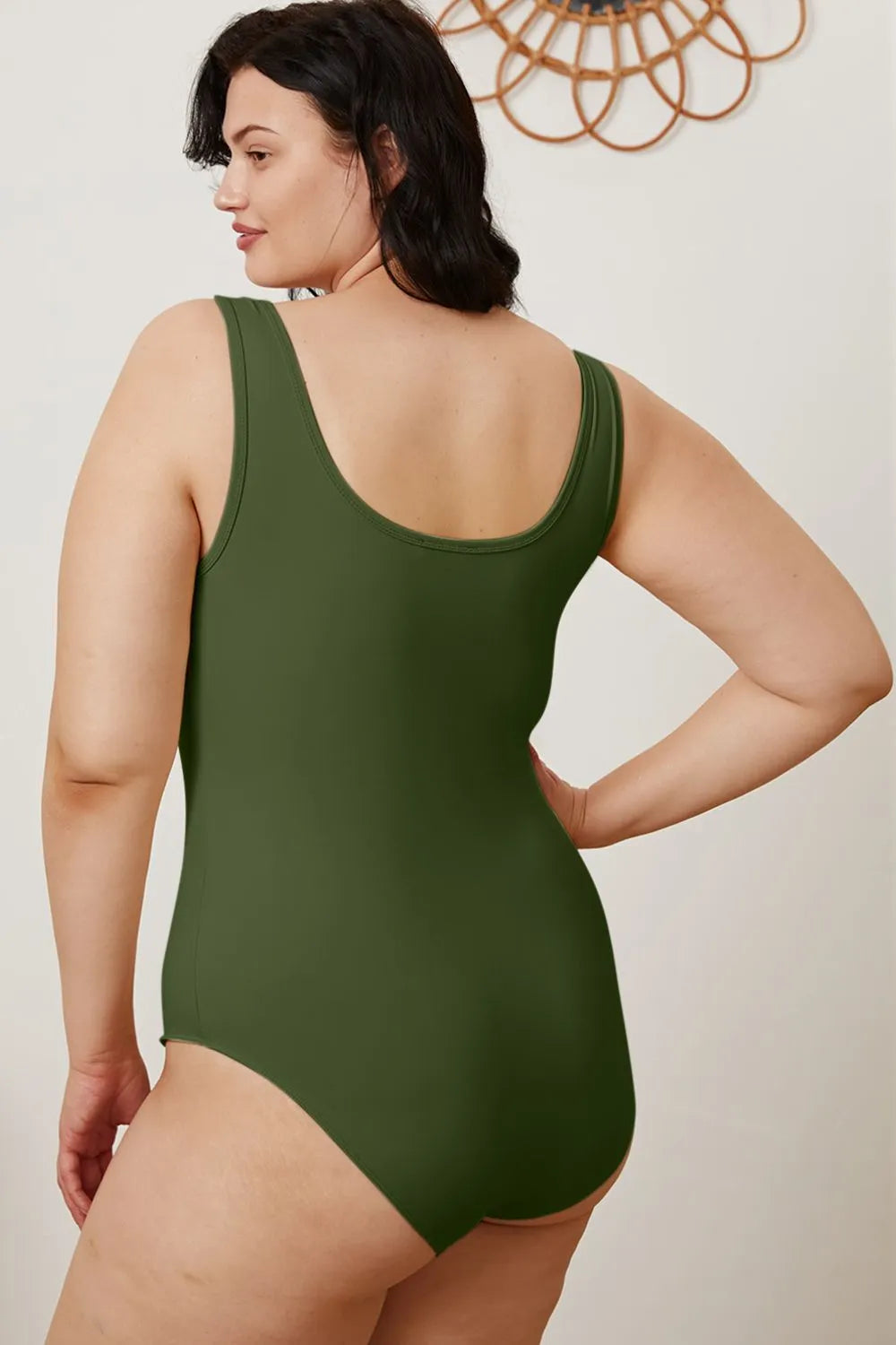 Dark green sleeveless bodysuit with scoop neckline, back view