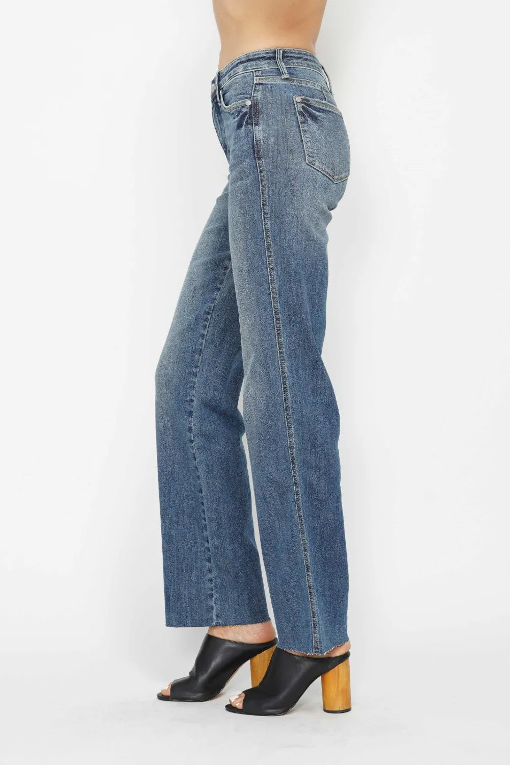 Side view medium wash straight jeans with front seam detail and classic pocket styling