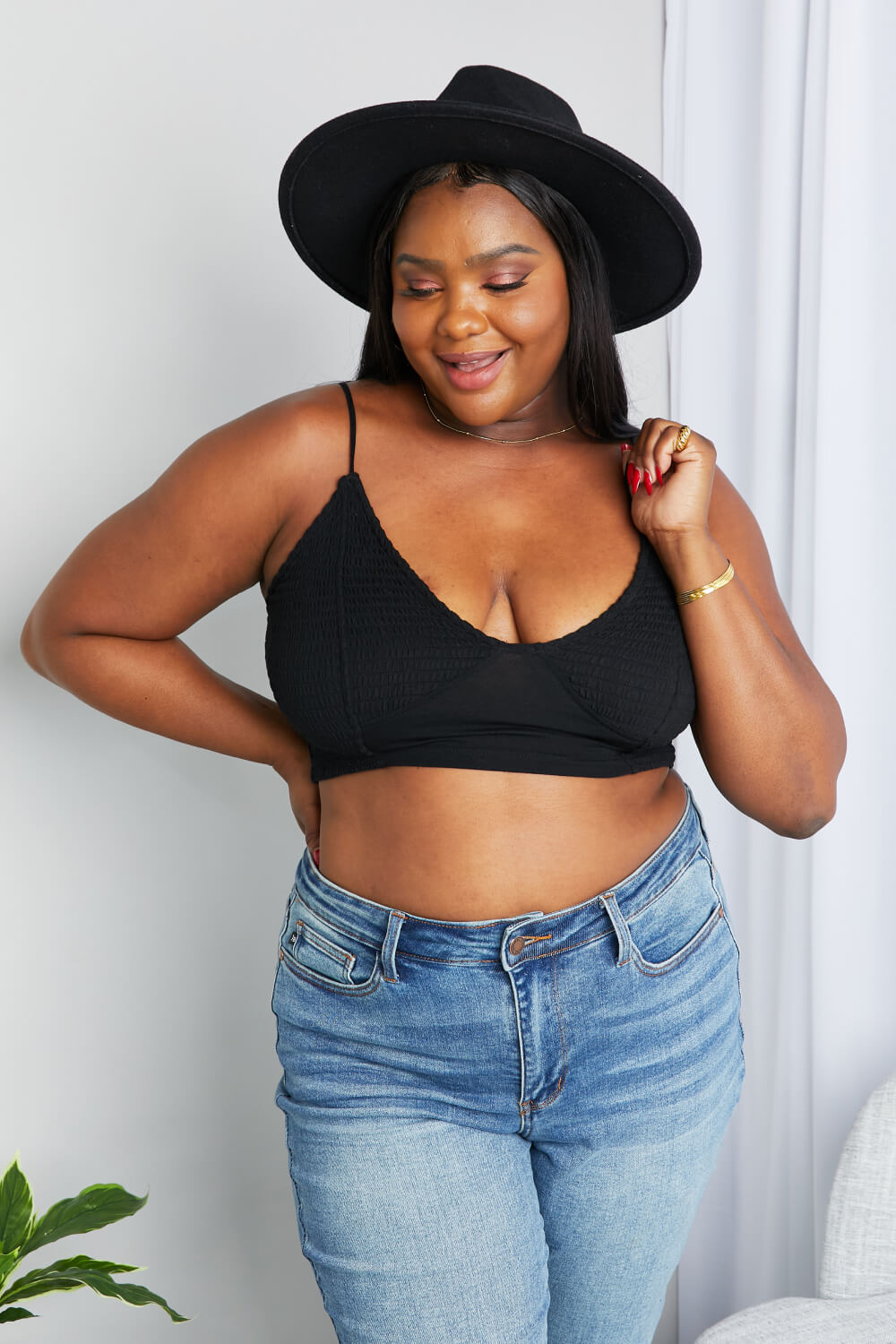 Black textured V-neck bralette with spaghetti straps and front twist detail