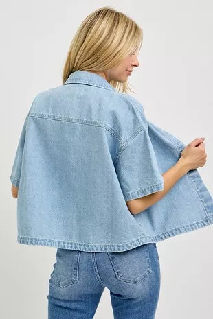 Light-wash oversized cropped denim shirt from back view, yoke seam and short sleeves