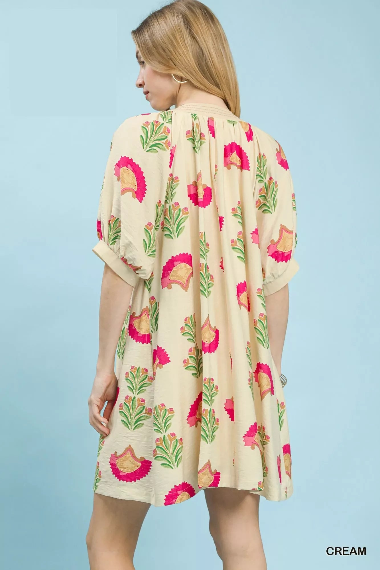 Cream mini dress back view with bird and leaf print, relaxed skirt