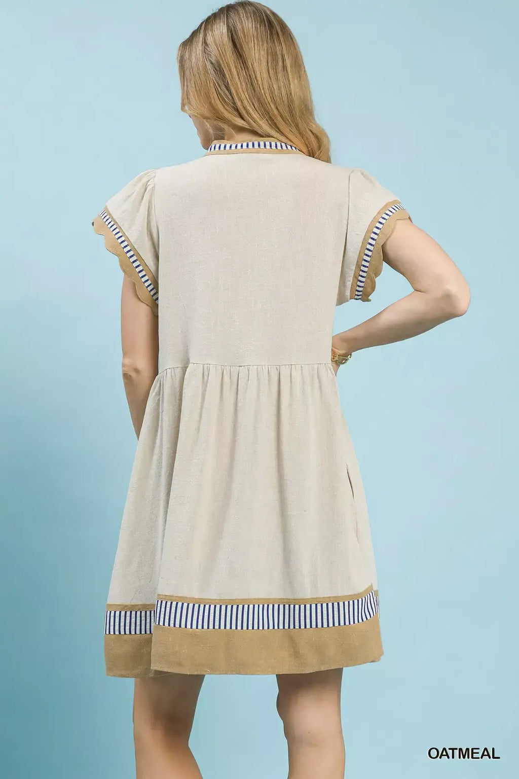 Back view of oatmeal linen flutter-sleeve dress with blue striped yoke and hem