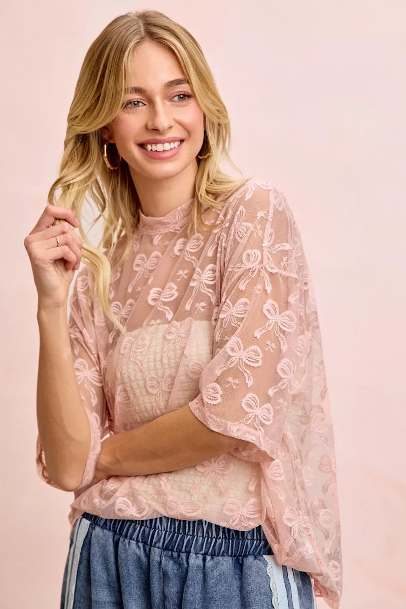 Dusty rose mesh top with allover bow pattern, short sleeves, crew neckline