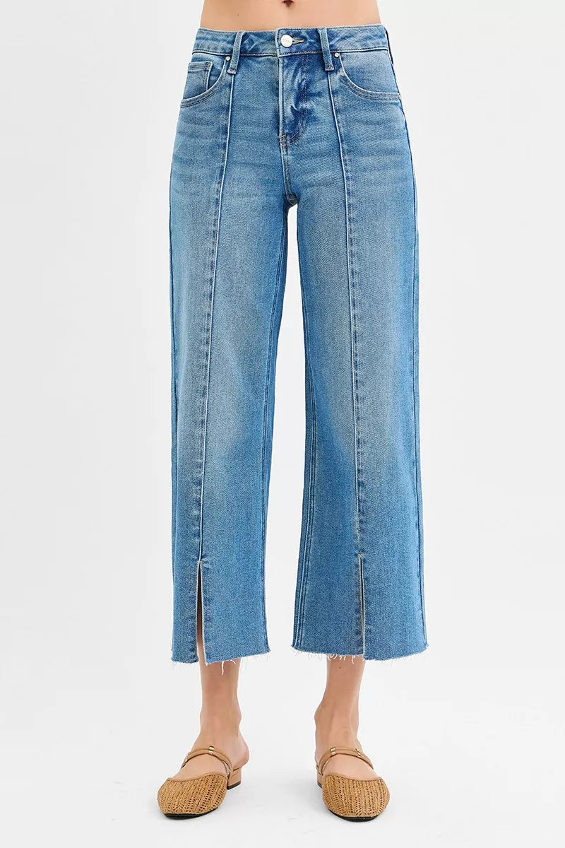 Medium-wash wide-leg jeans, mid rise, back view with front slit detail