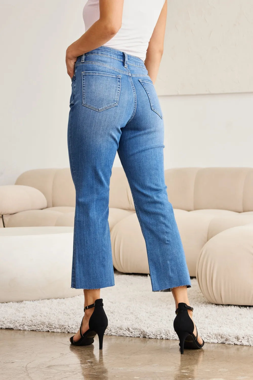 Side view medium wash high-waist tummy-control jeans, straight-to-flare crop