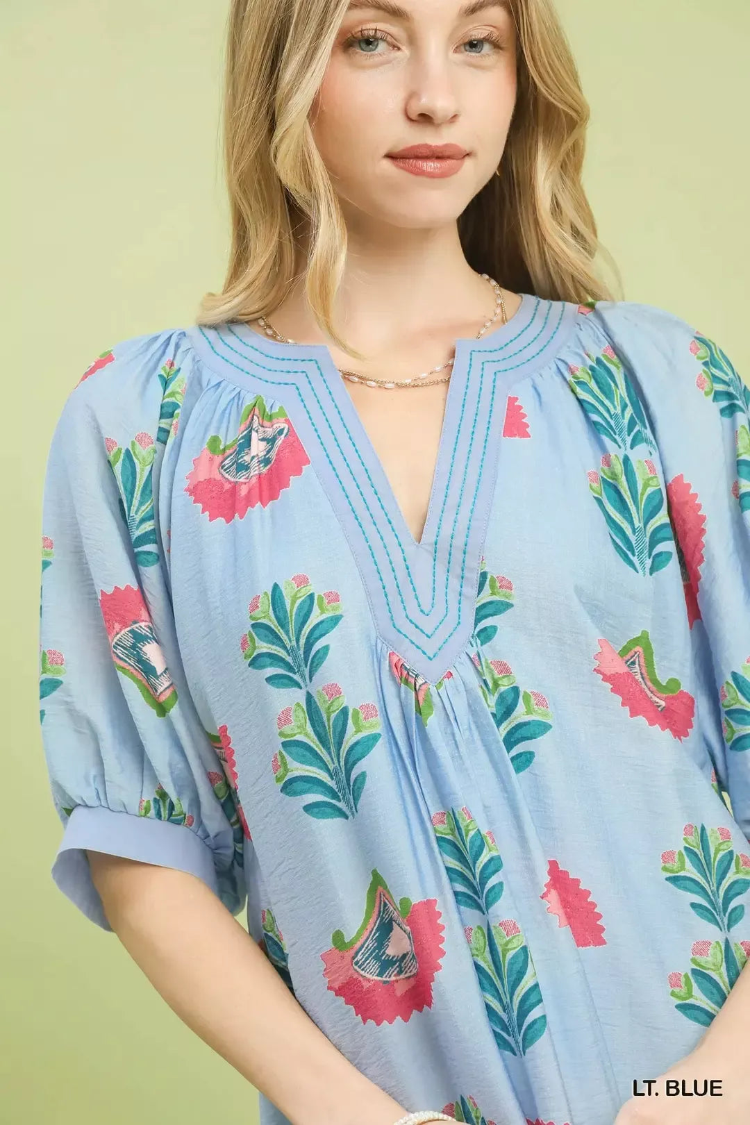 Light blue V-neck mini dress close-up with bird and leaf print