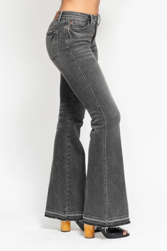 Washed gray mid-rise flare jeans, angled view with frayed release hem and back pocket yoke