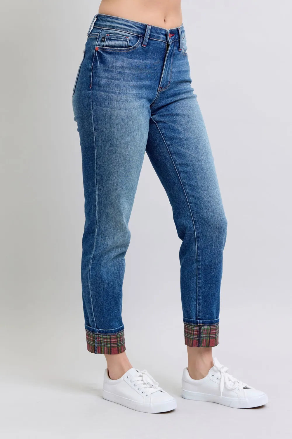 Medium wash jeans front seam detail and plaid cuff at hem
