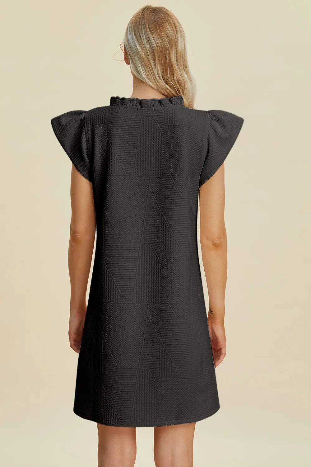 Ruffled V-neck cap sleeve dress in black, back view with gathered ruffled cap sleeves.