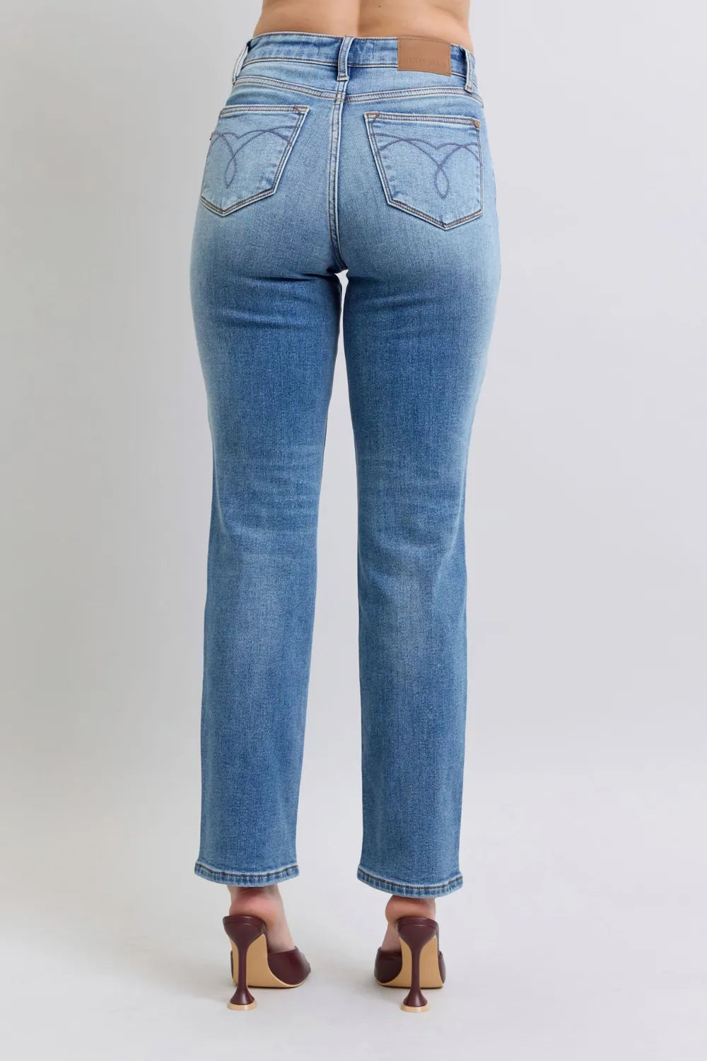 Back view of medium-wash vintage straight jeans with rear pockets and belt loops