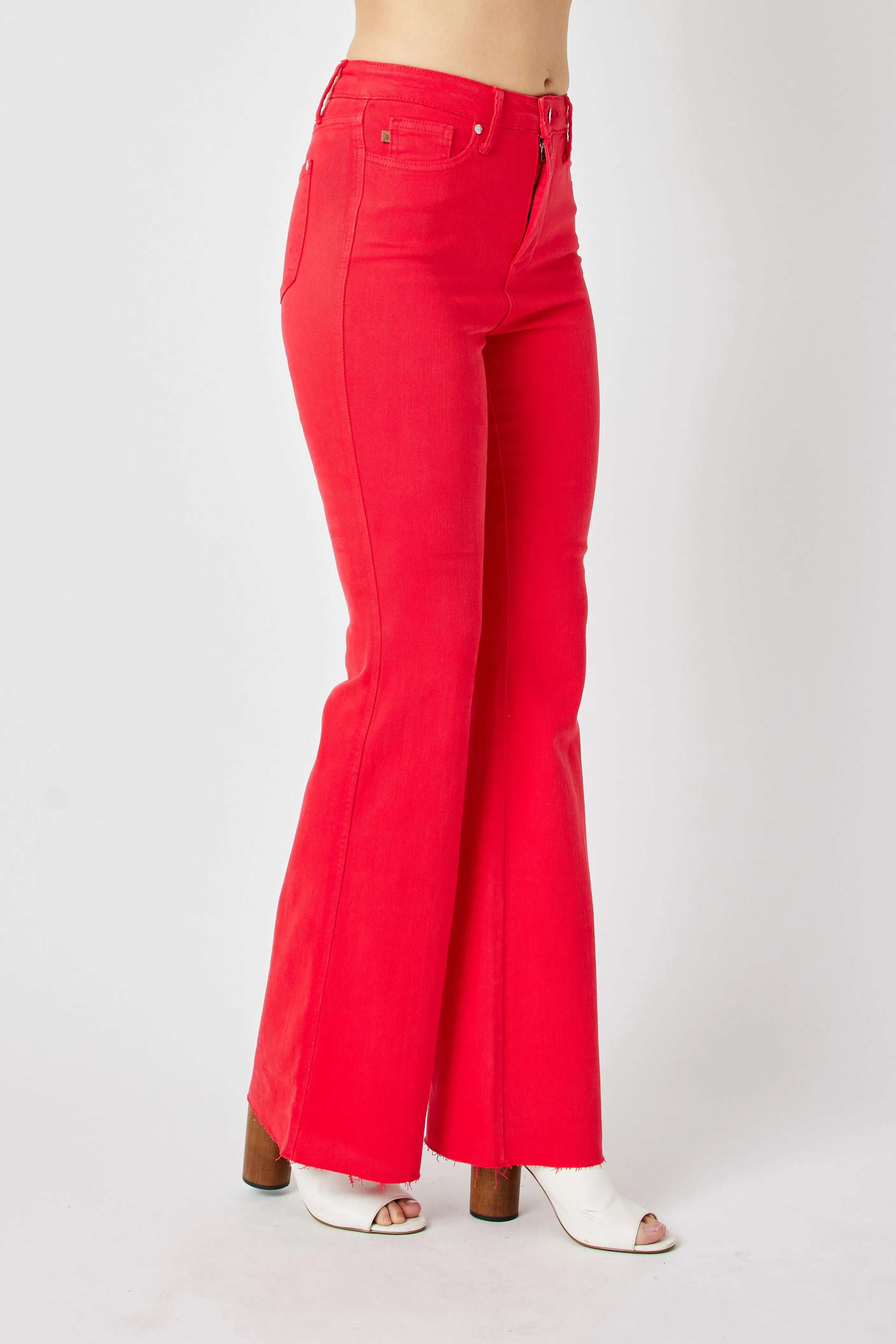 Red high-rise flare jeans, back view with flared hem and rear pocket details