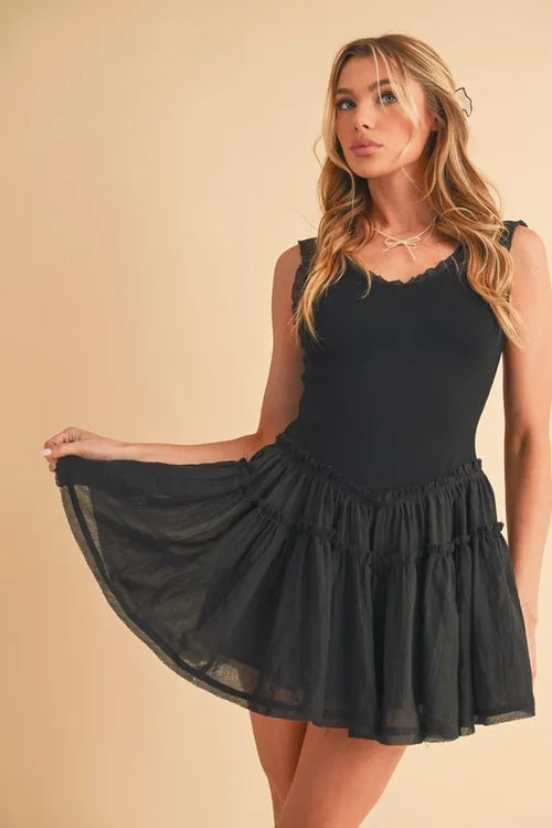 Black sleeveless mini dress with frill neckline and drop-waist tiered skirt