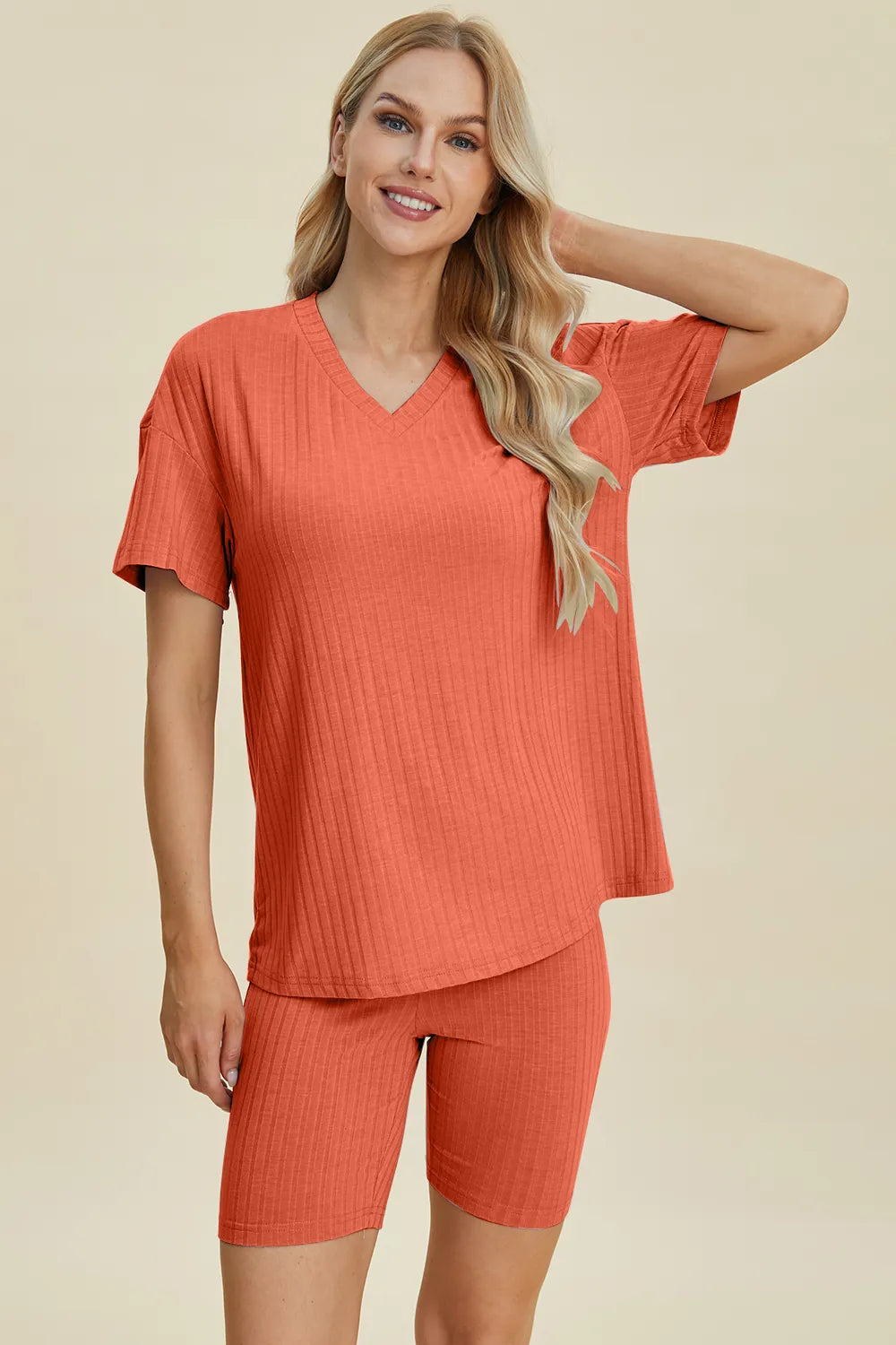 Coral ribbed V-neck short sleeve top and matching biker shorts set, side front view