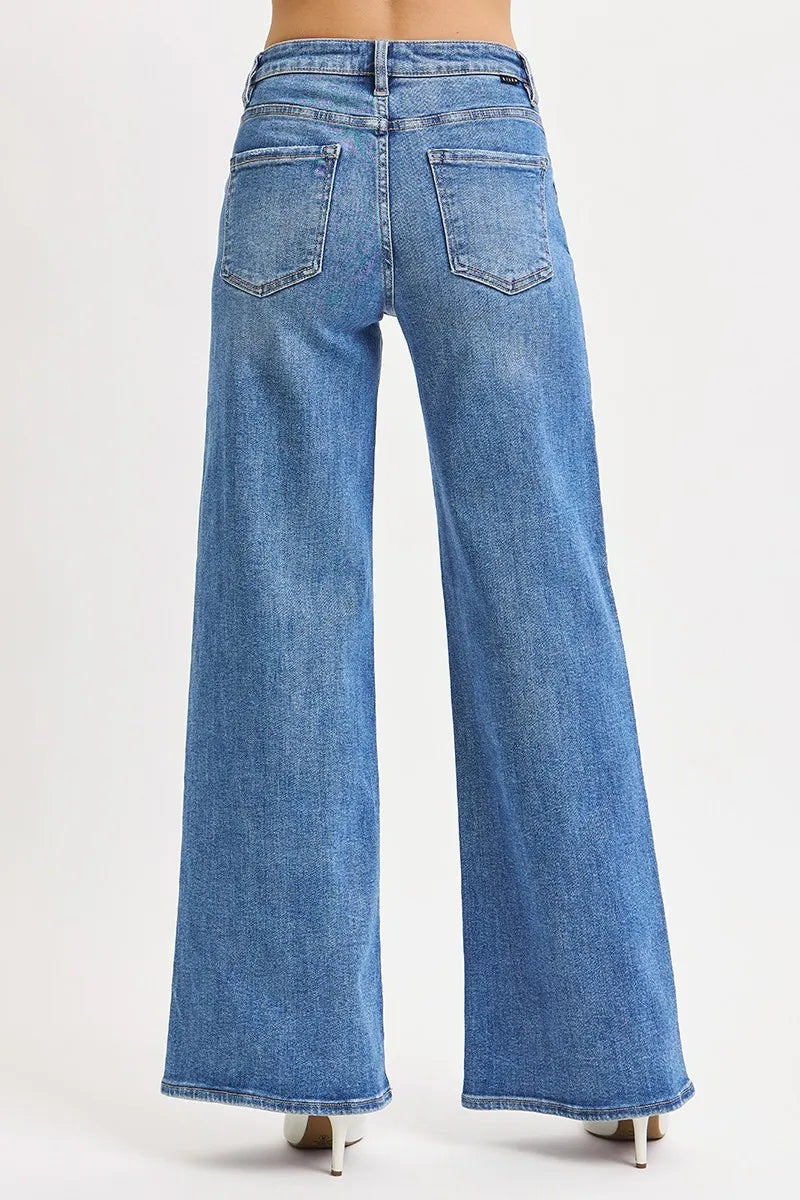 Back view high-rise wide-leg jeans, medium wash blue with two patch back pockets.