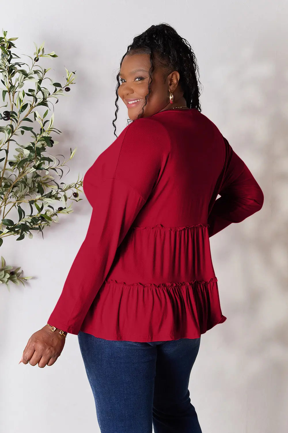 Burgundy long-sleeve blouse with gathered waist and tiered ruffle hem, back view
