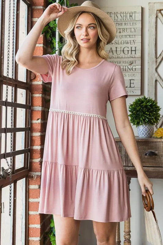 Dusty rose tiered mini dress with lace pom-pom trim, short sleeves, front view