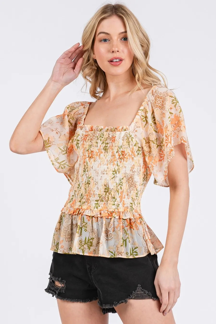 Orange multi floral peplum top with puff sleeves and elastic smocked center