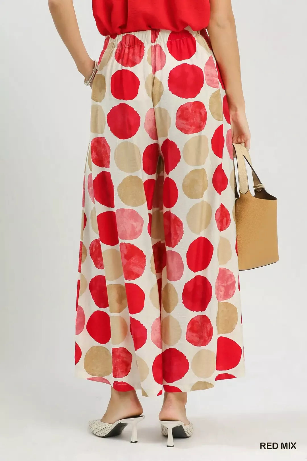 Red dot-print wide-leg pants with elastic waist and wide flowing legs, full length