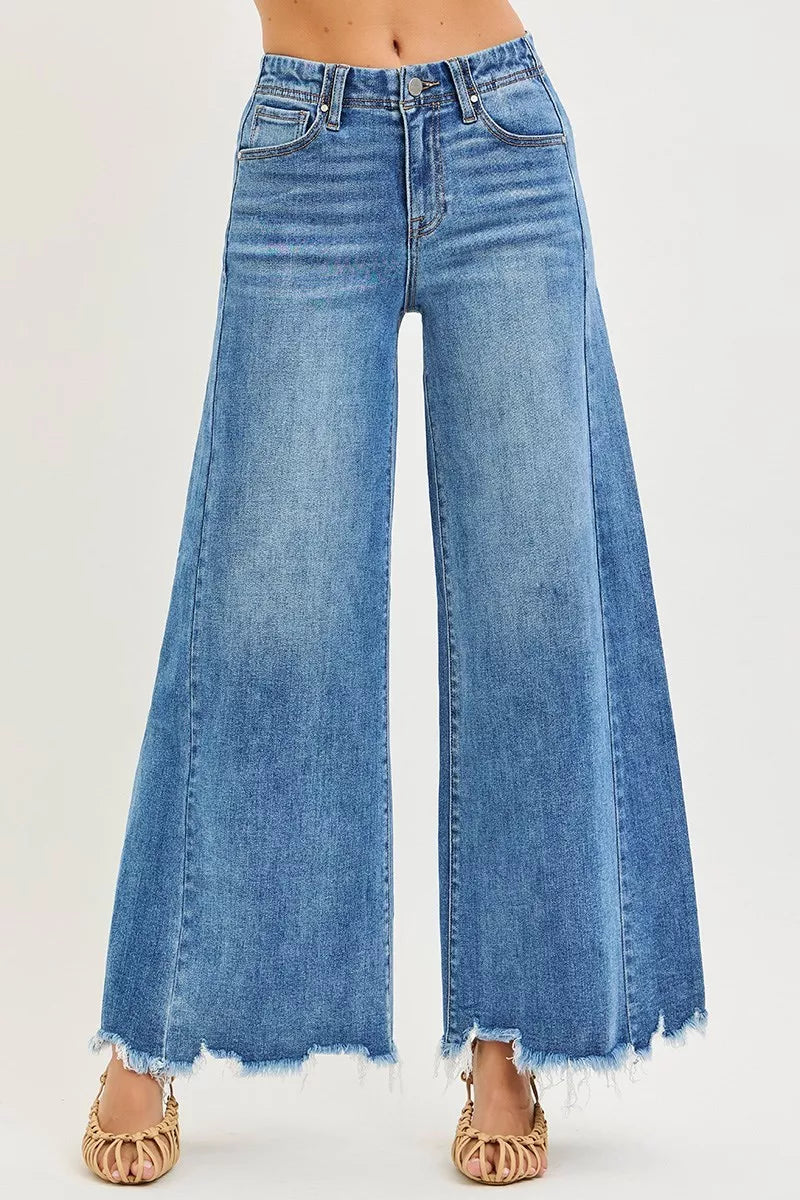 High-rise wide-leg jeans in medium wash, button fly, frayed ankle hem