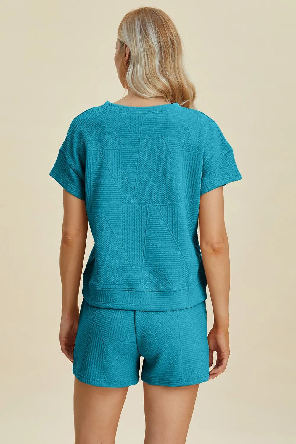 Cerulean back view: textured short-sleeve top and matching shorts with drawstring.