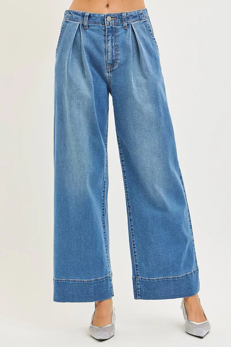 Medium-wash wide-leg jeans with pleated, slouchy waistband and button fly
