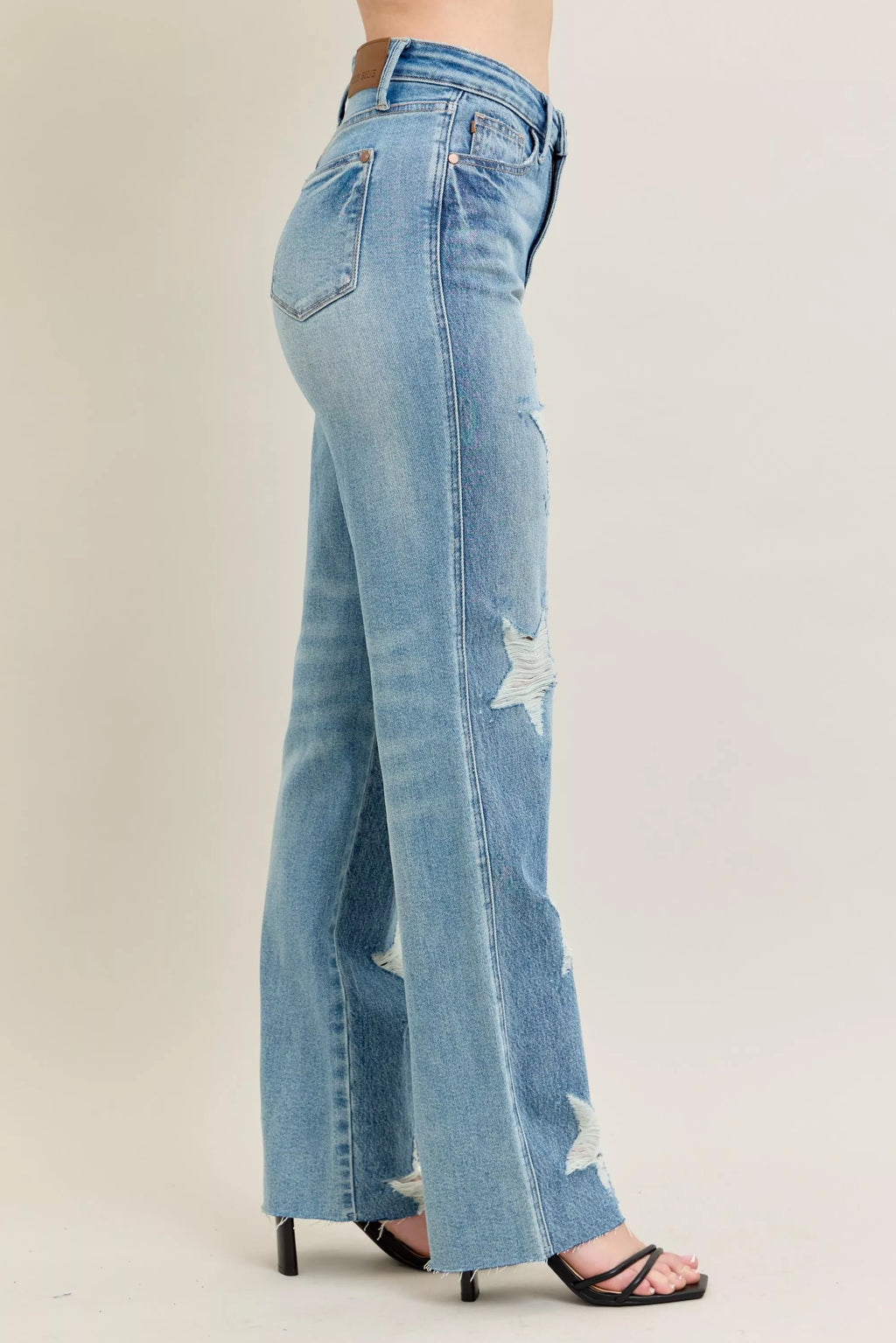 High-waist light-wash straight jeans with star-shaped destroy rips