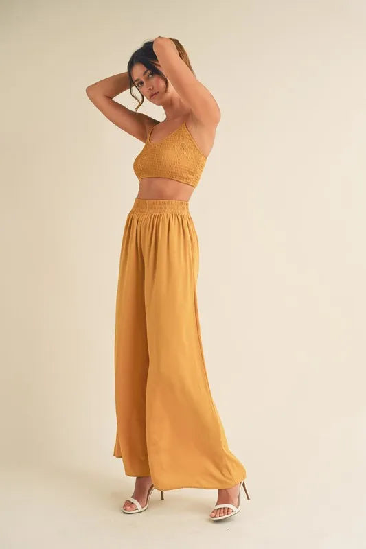 Gold mustard smocked bralette crop top with wide-leg pants, full length and drape