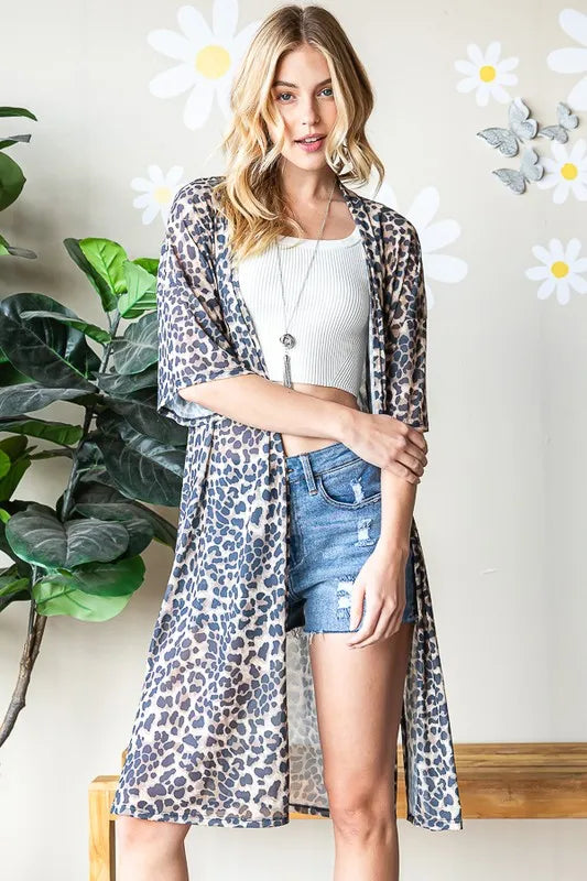 Taupe leopard open-front cardigan draped over a white top, short sleeves