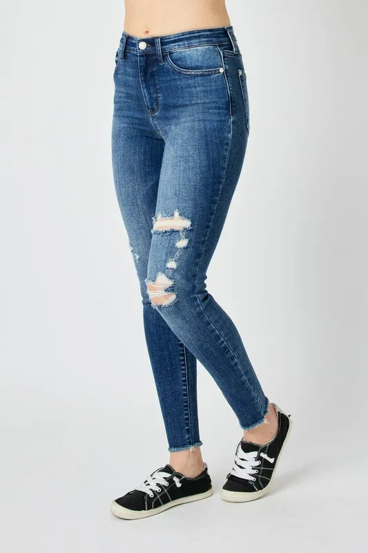 Dark blue high-waist skinny jeans with center back seam and ripped front detail