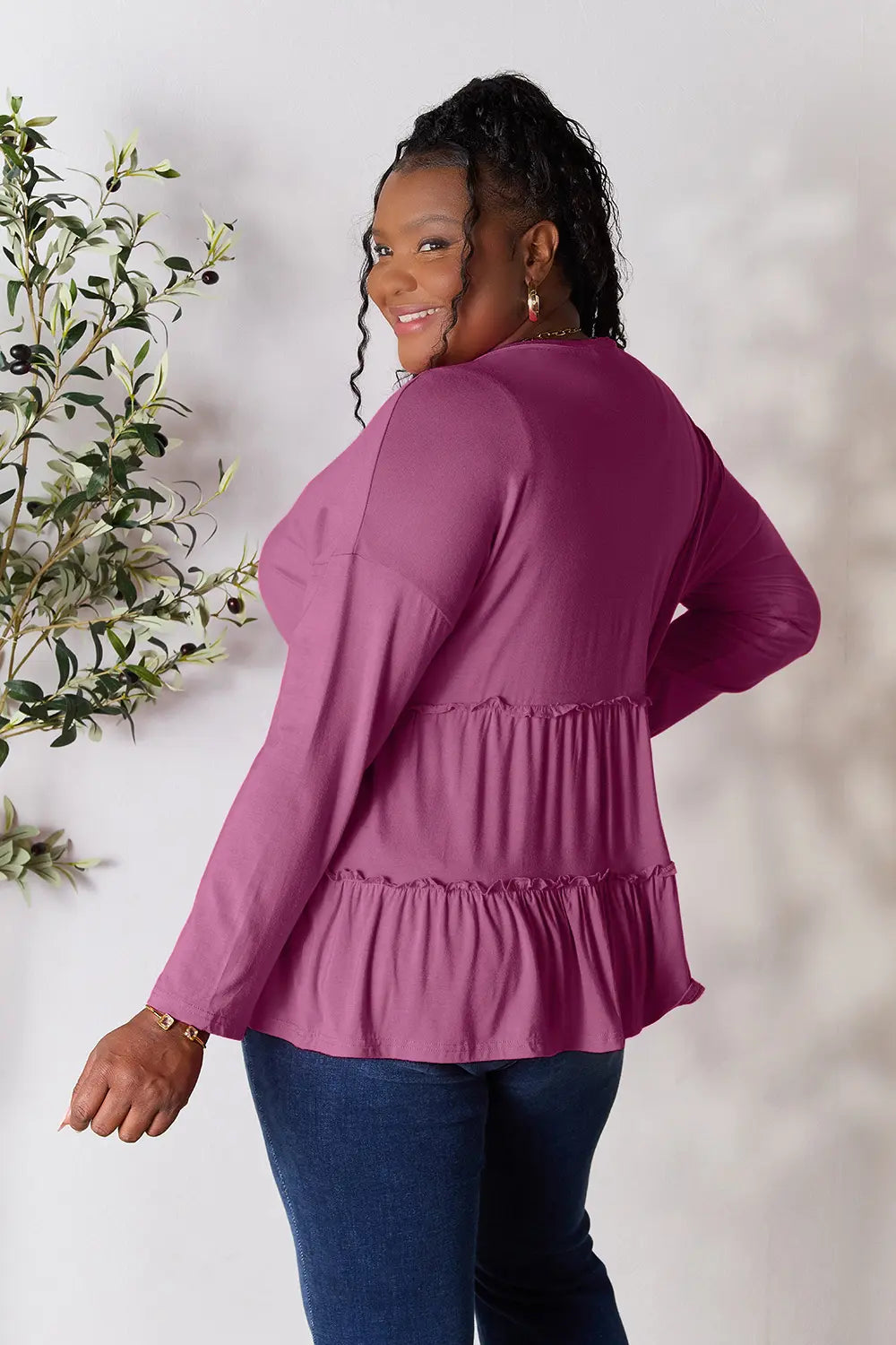 Lilac long-sleeve blouse back view with tiered ruffle hem and gathered waist