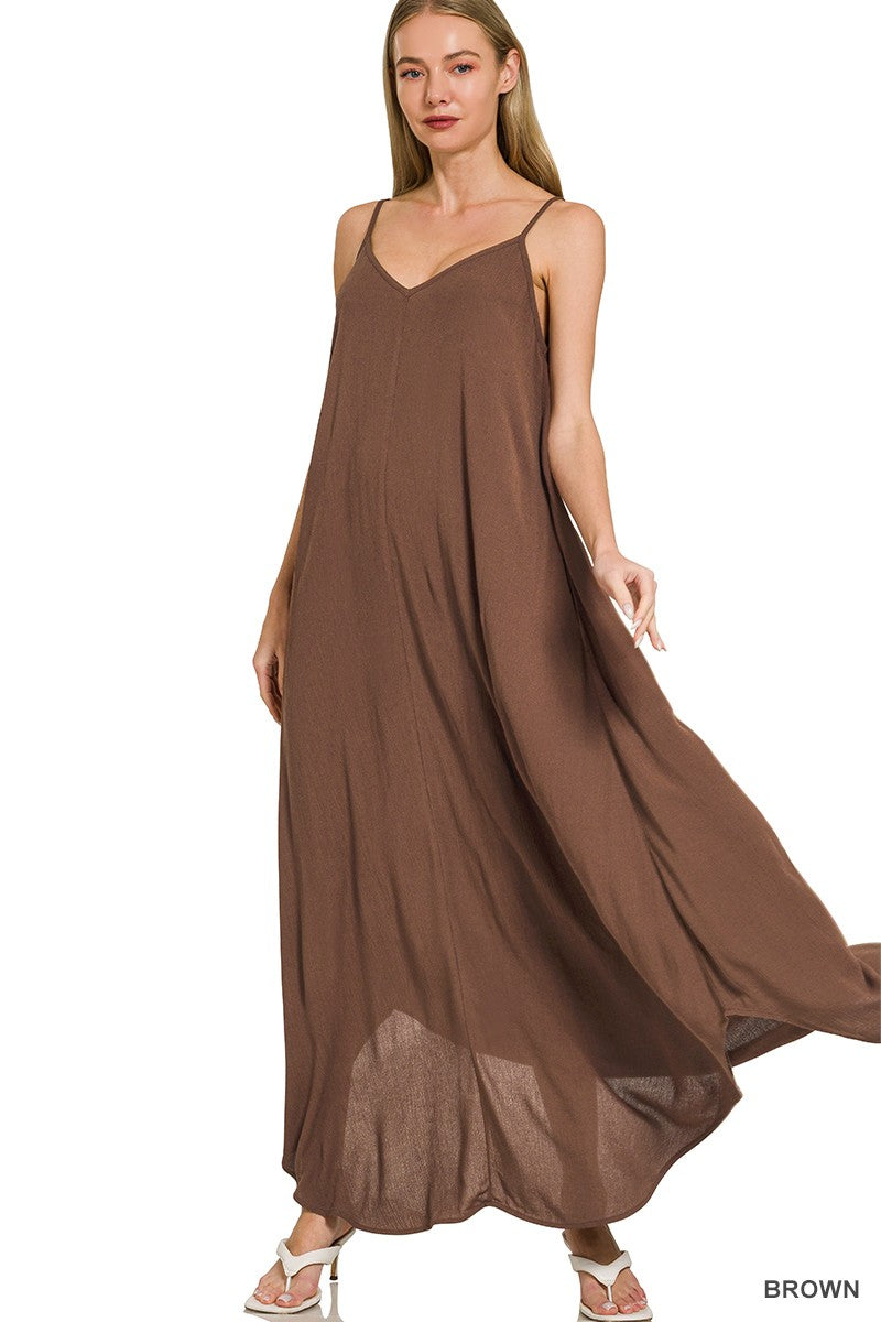 Brown flowy woven maxi dress with adjustable spaghetti straps and side pockets