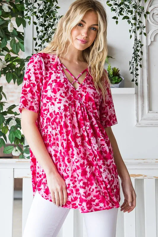 Hot pink animal-print babydoll tunic with crisscross front and short sleeves
