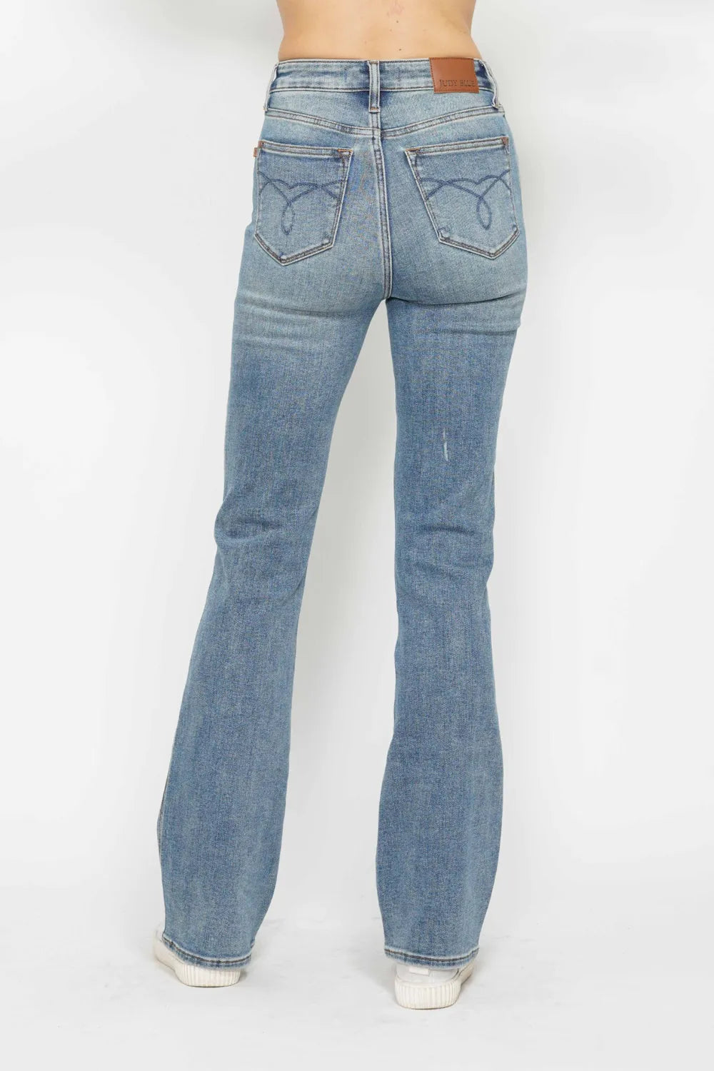 Light blue bootcut jeans, embroidered back pockets and rear seam detailing