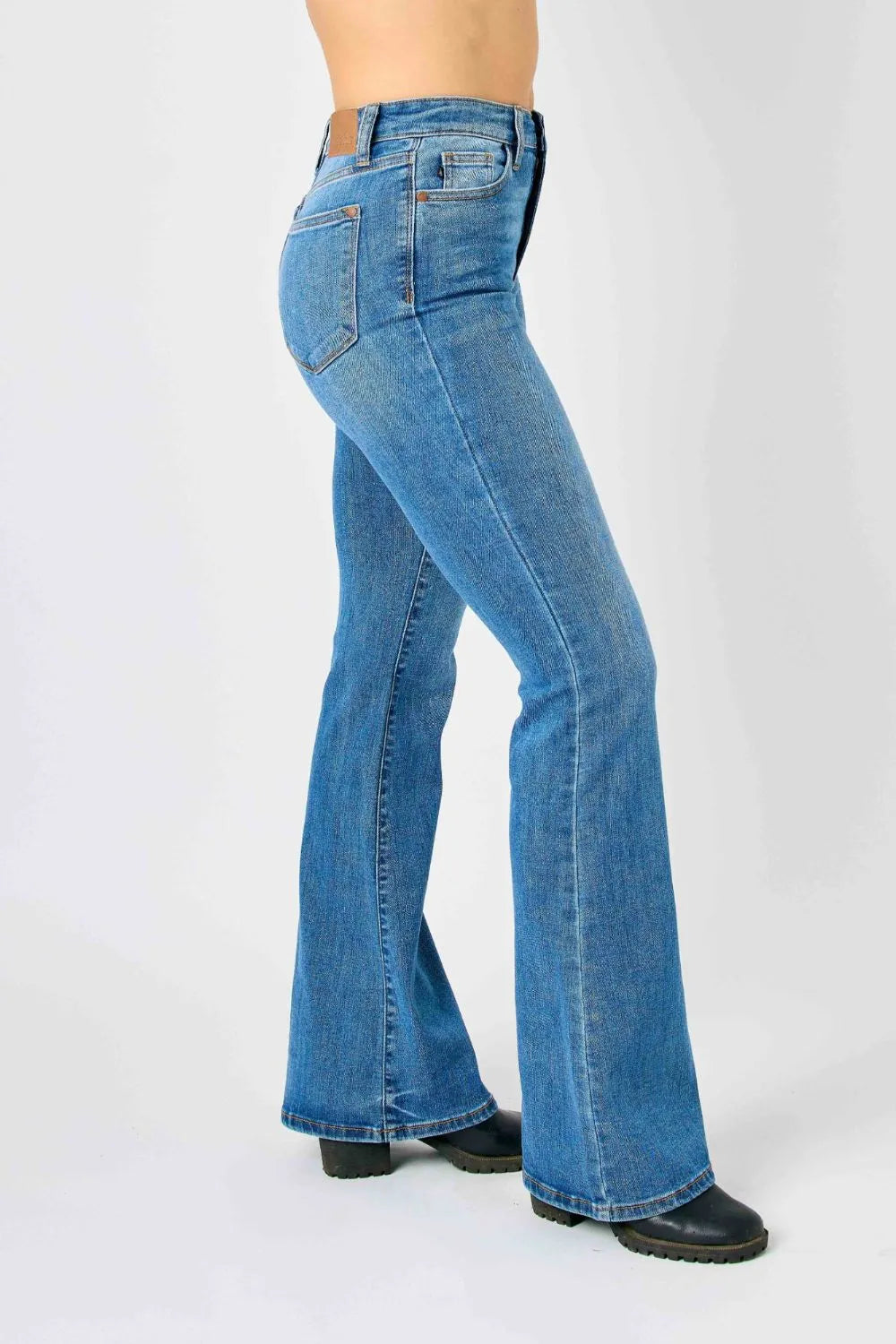 Front/side view of medium-blue high-waisted flare jeans with belt loops