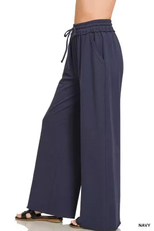 Navy wide-leg French terry sweatpants with adjustable drawstring and relaxed drape