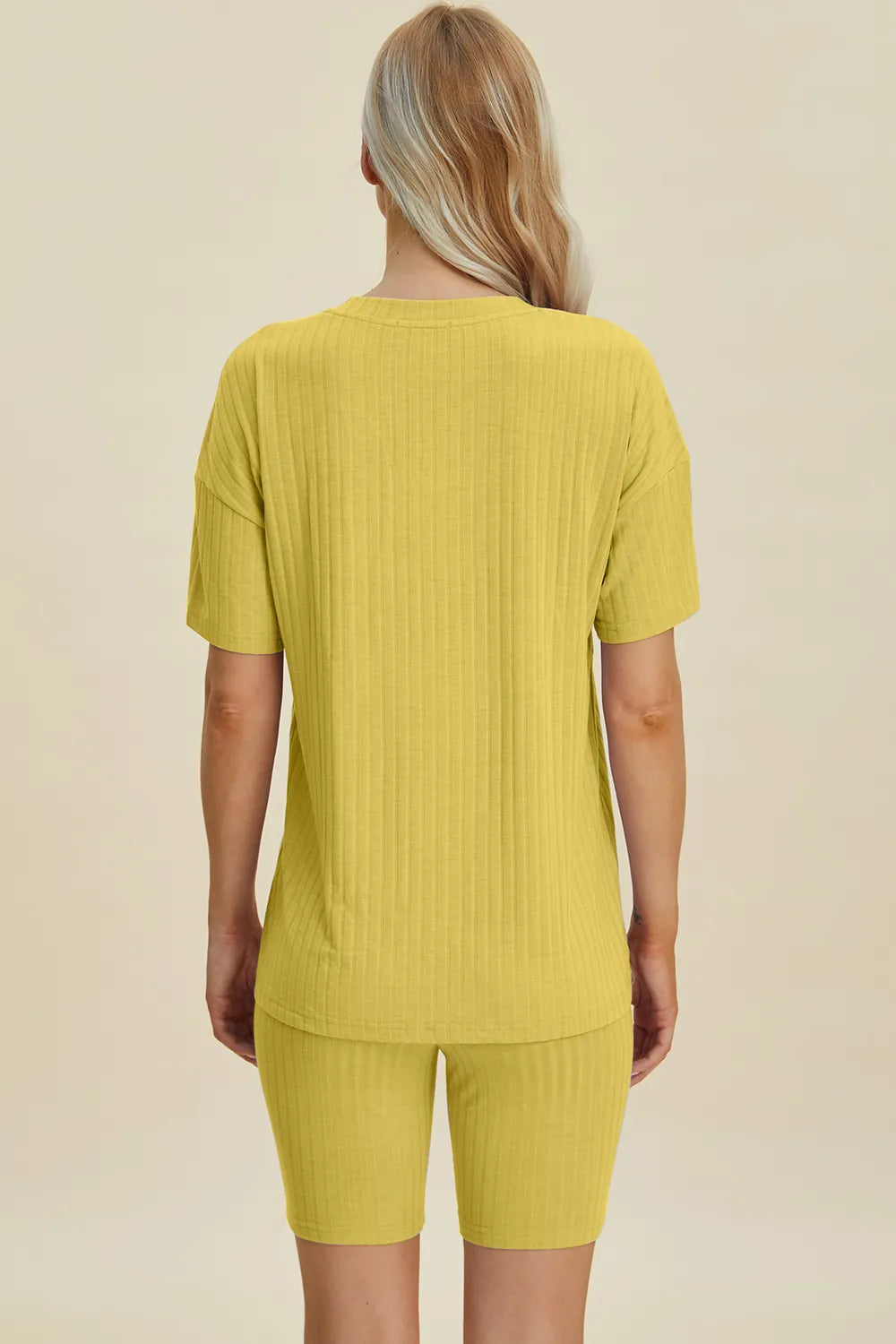 Yellow ribbed V-neck short sleeve top and matching biker shorts set, back view