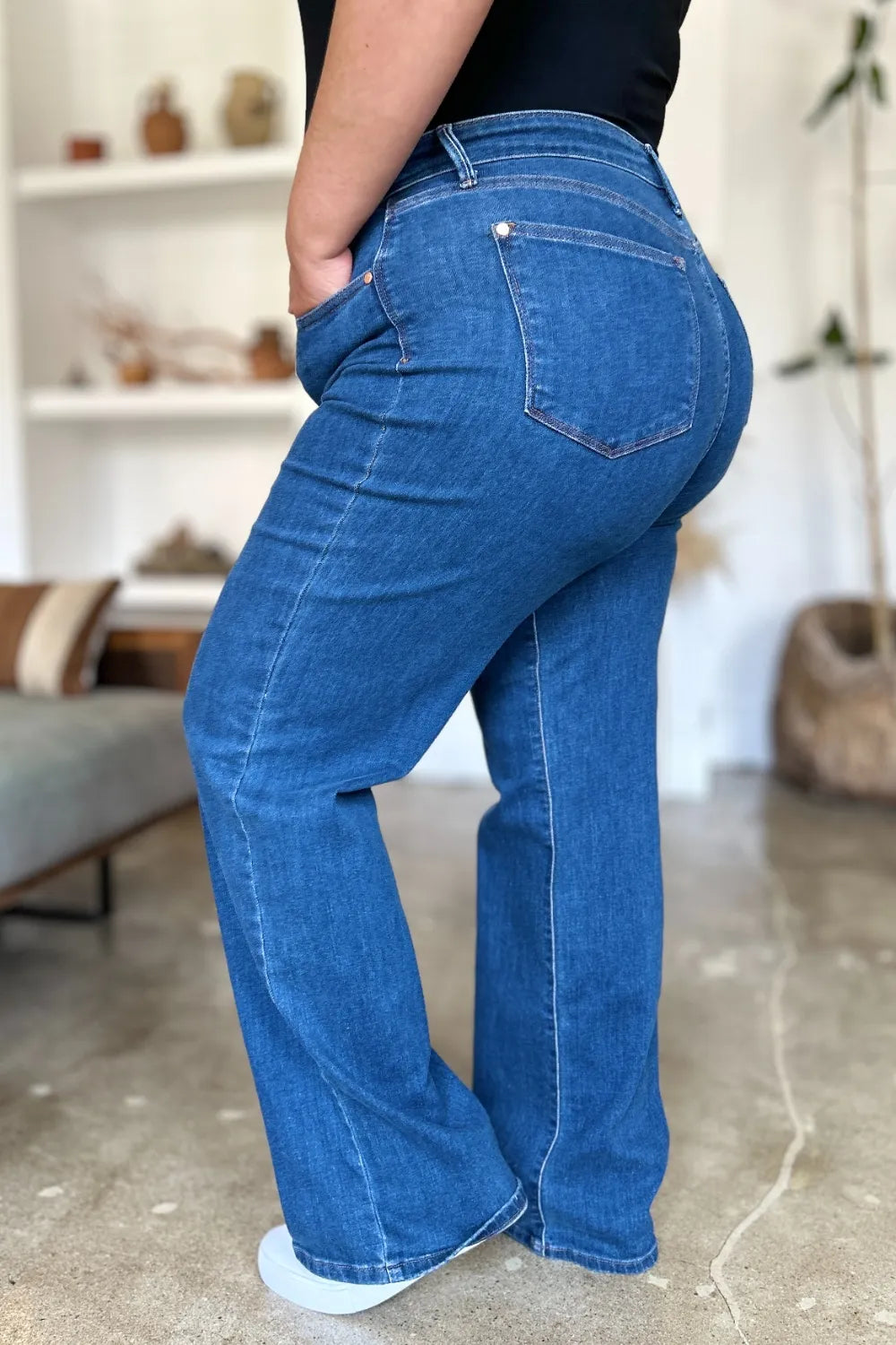 Medium blue high rise straight jeans, back view with stitched back pockets