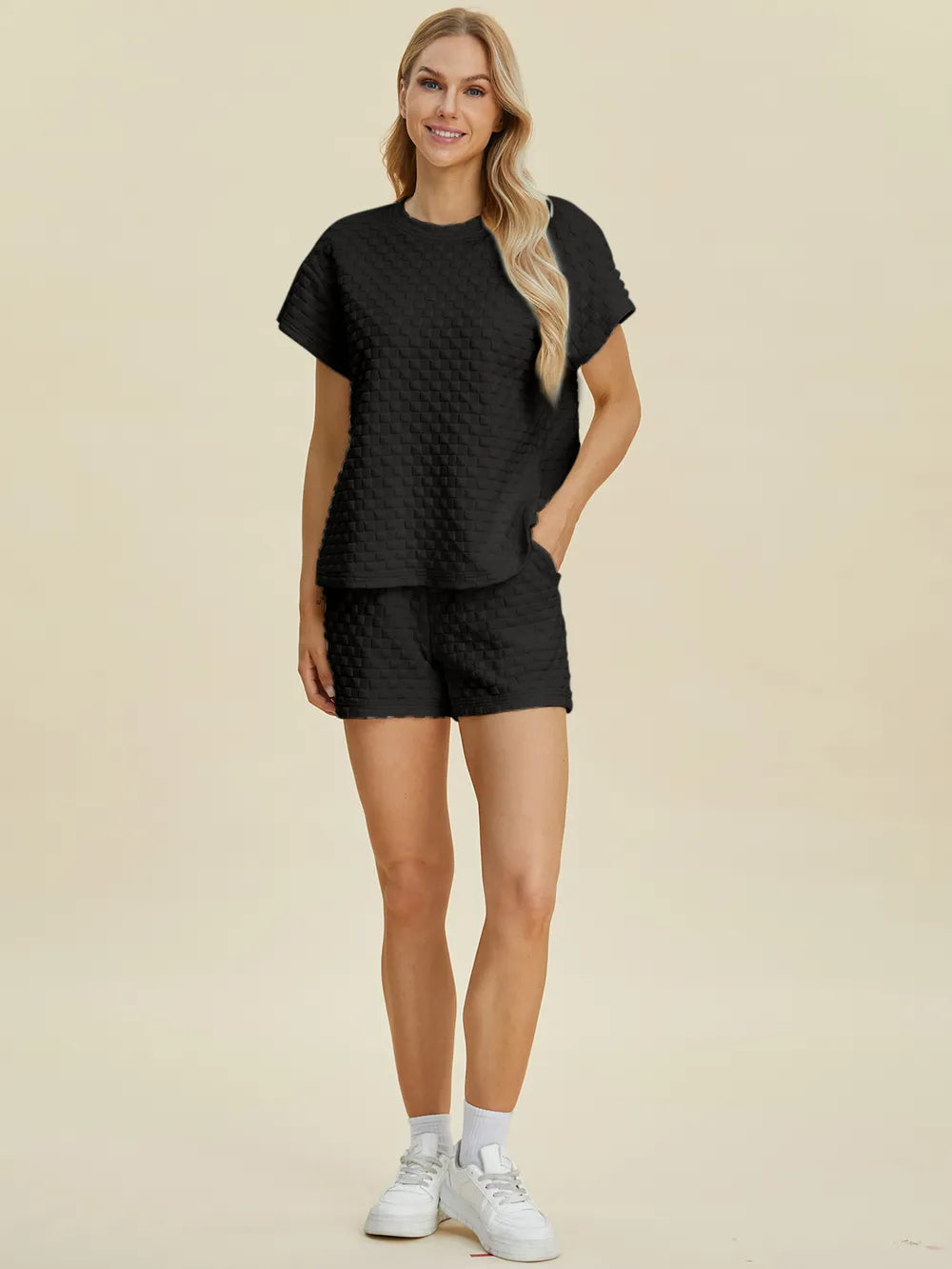 Black textured T-shirt and shorts set, side view with short sleeves and relaxed shorts.