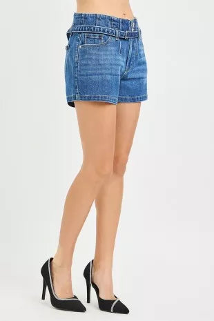 Dark-wash denim shorts side view with cuffed hem and belt loops