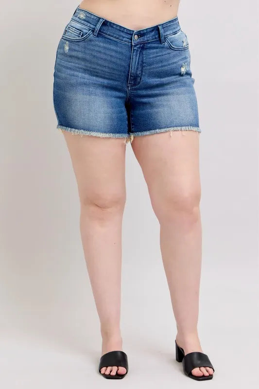 Front view of blue denim shorts with button fly, front pockets, and frayed hem