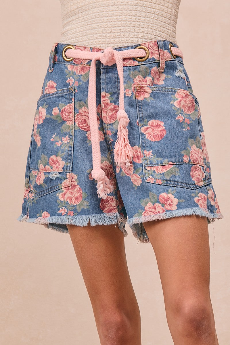 Blue denim floral shorts with braided waist belt, patch pockets, frayed hem