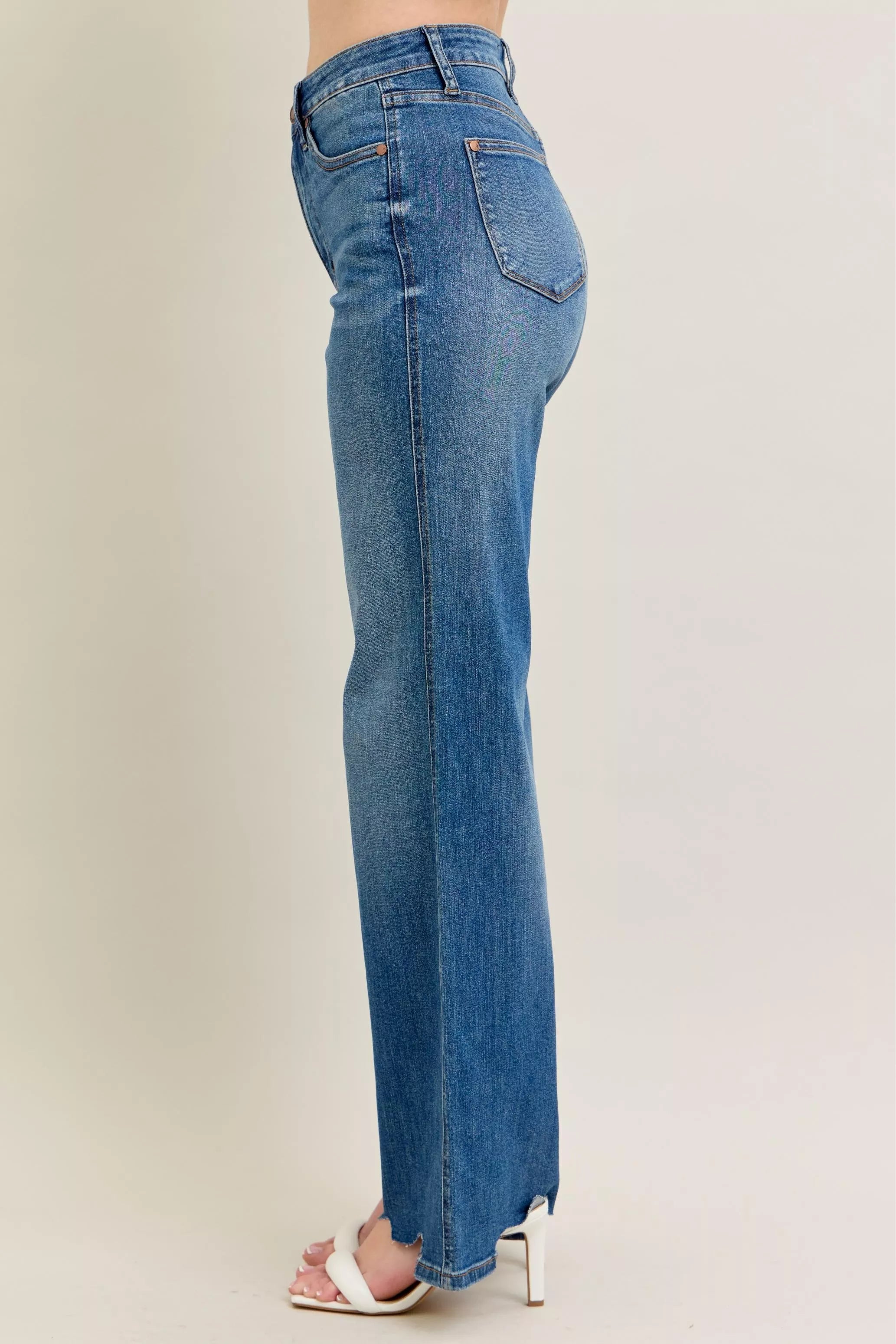 Back/side view: medium-wash wide-leg jeans with distressed hem