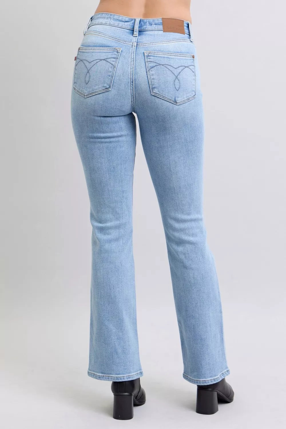 Back view light wash bootcut jeans, mid-rise with two back pockets