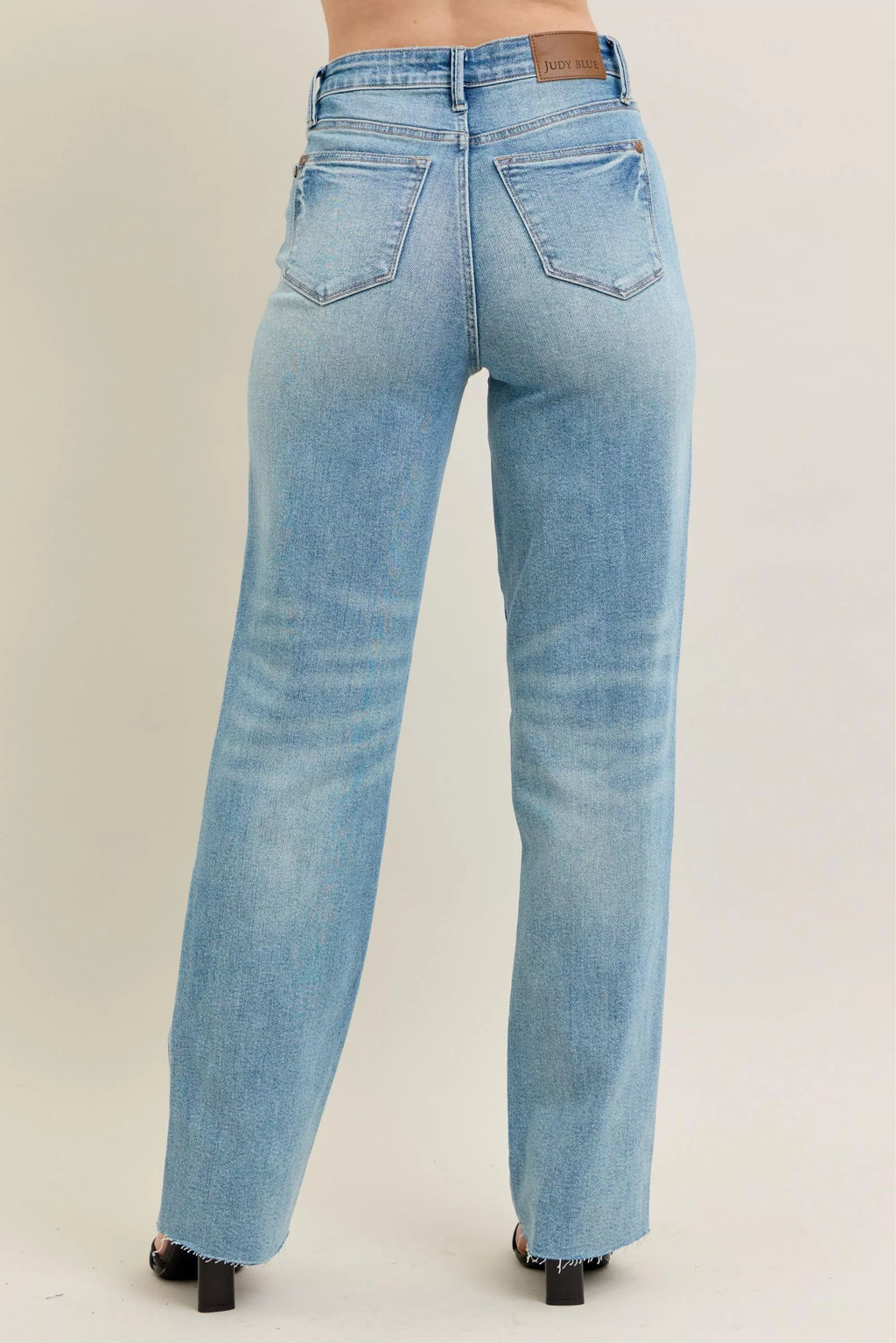 Back view: light-wash straight jeans with belt loops and five-pocket seams