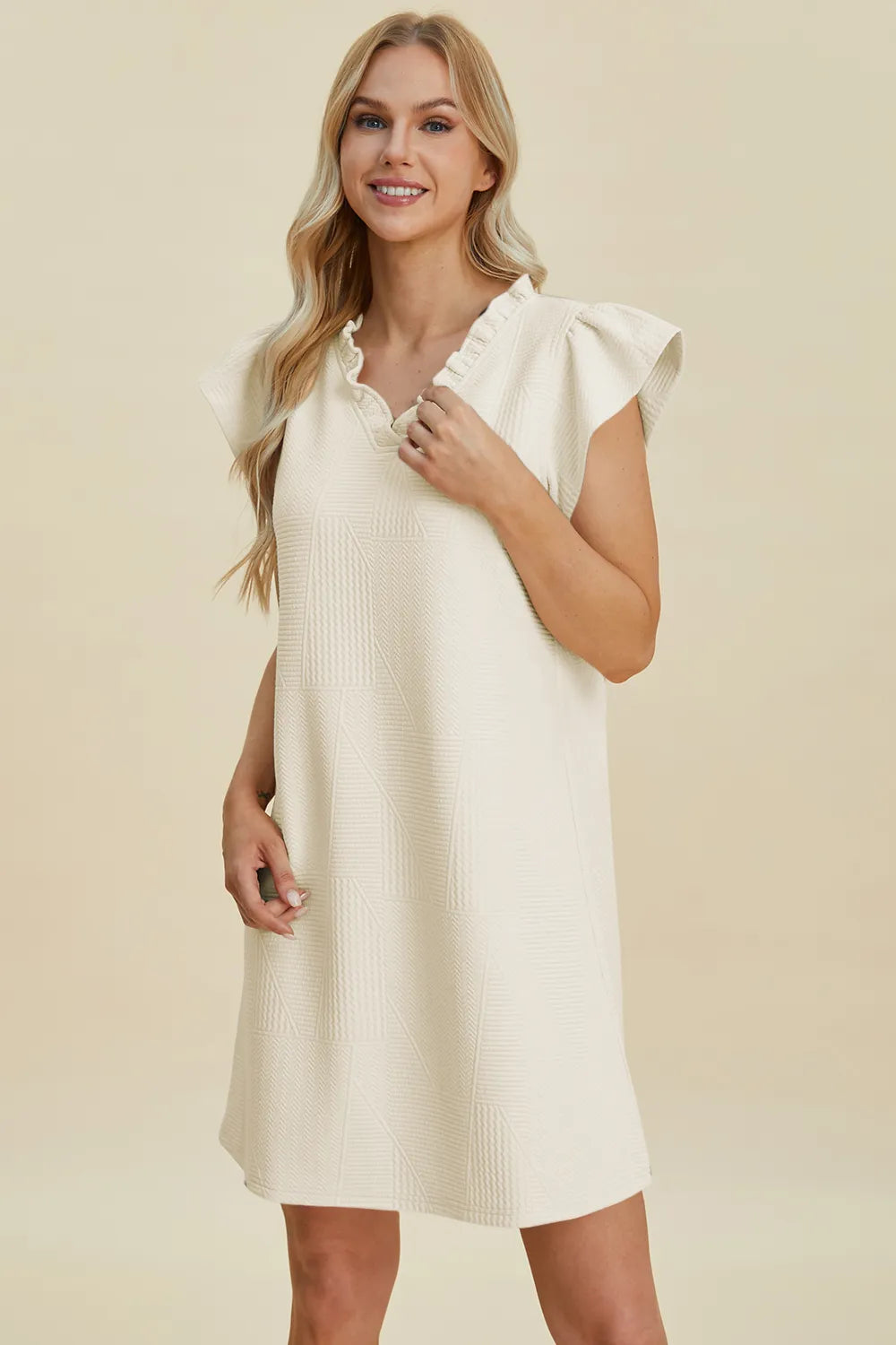 Cream ruffled V-neck cap sleeve dress with textured pattern