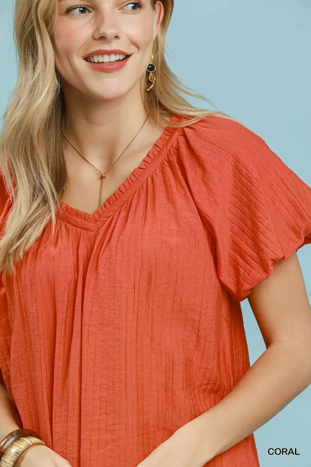 Coral gathered V-neck neckline with short puff sleeves