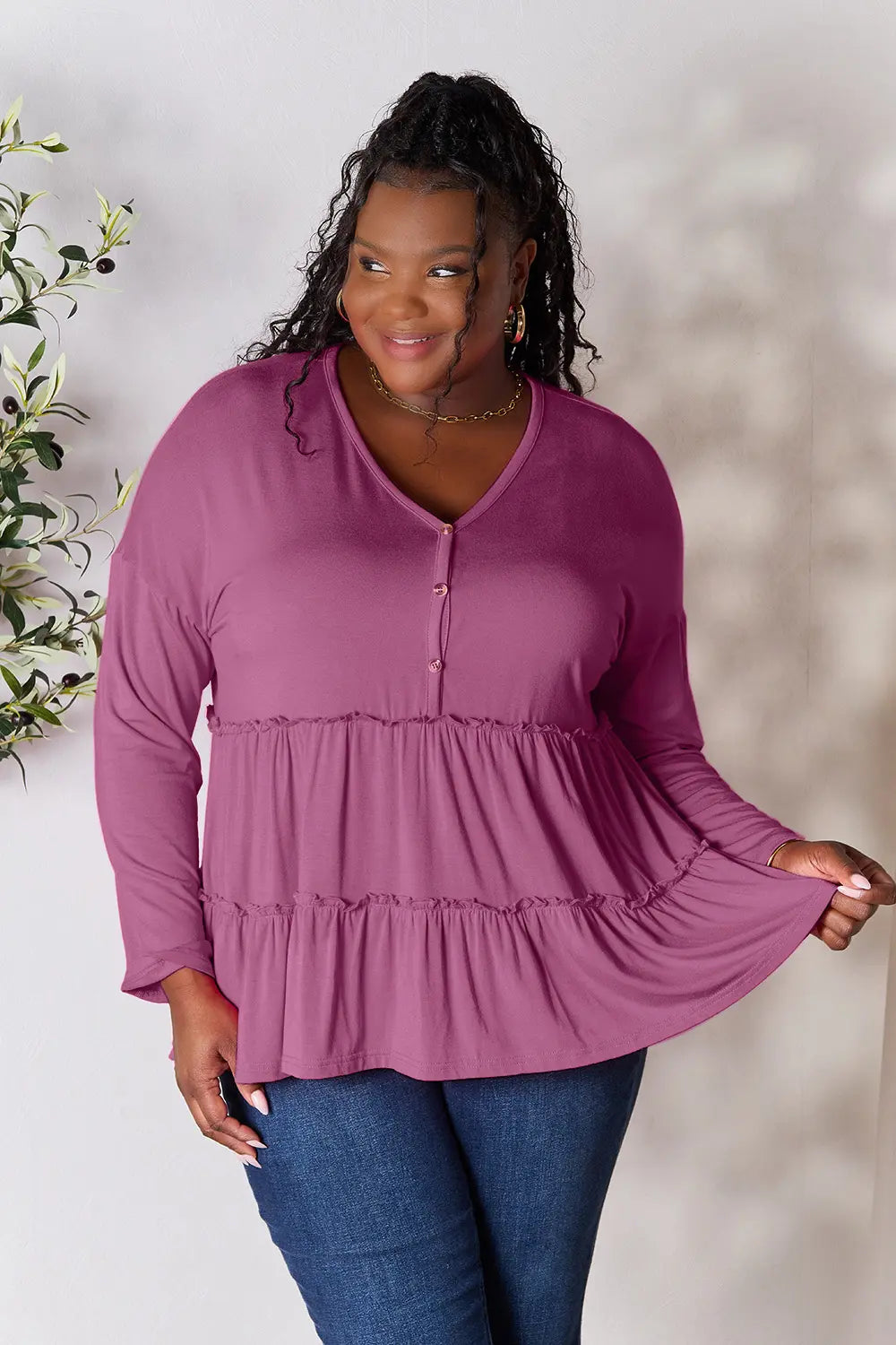 Lilac long-sleeve blouse with V-neck, half-button front, and tiered ruffle hem