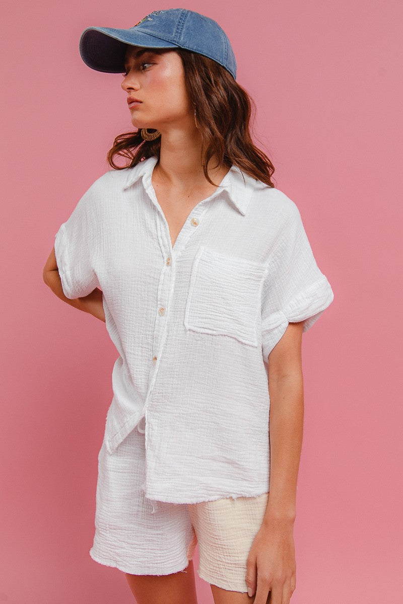 Off-white wrinkled gauze shirt set: collared button-up top with chest pocket, matching shorts