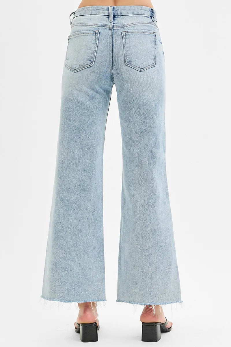 Light-wash wide-leg jeans back view, two back pockets, frayed raw hem