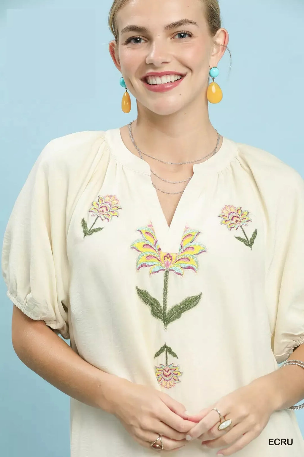 Ecru embroidered floral babydoll dress with V-neck and colorful flower motif